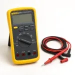 Yellow digital multimeter with red and black test leads