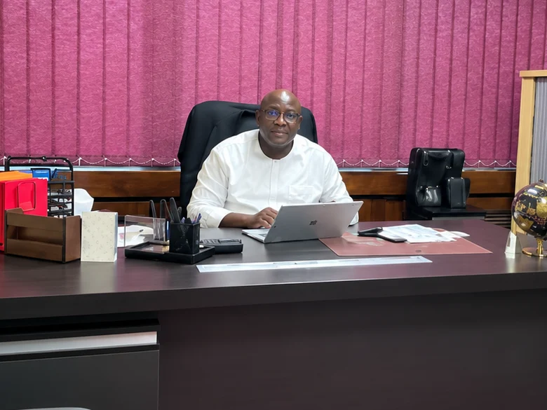 Frank Mwamba, Managing Director of Master Transact Limited, seated in his office.